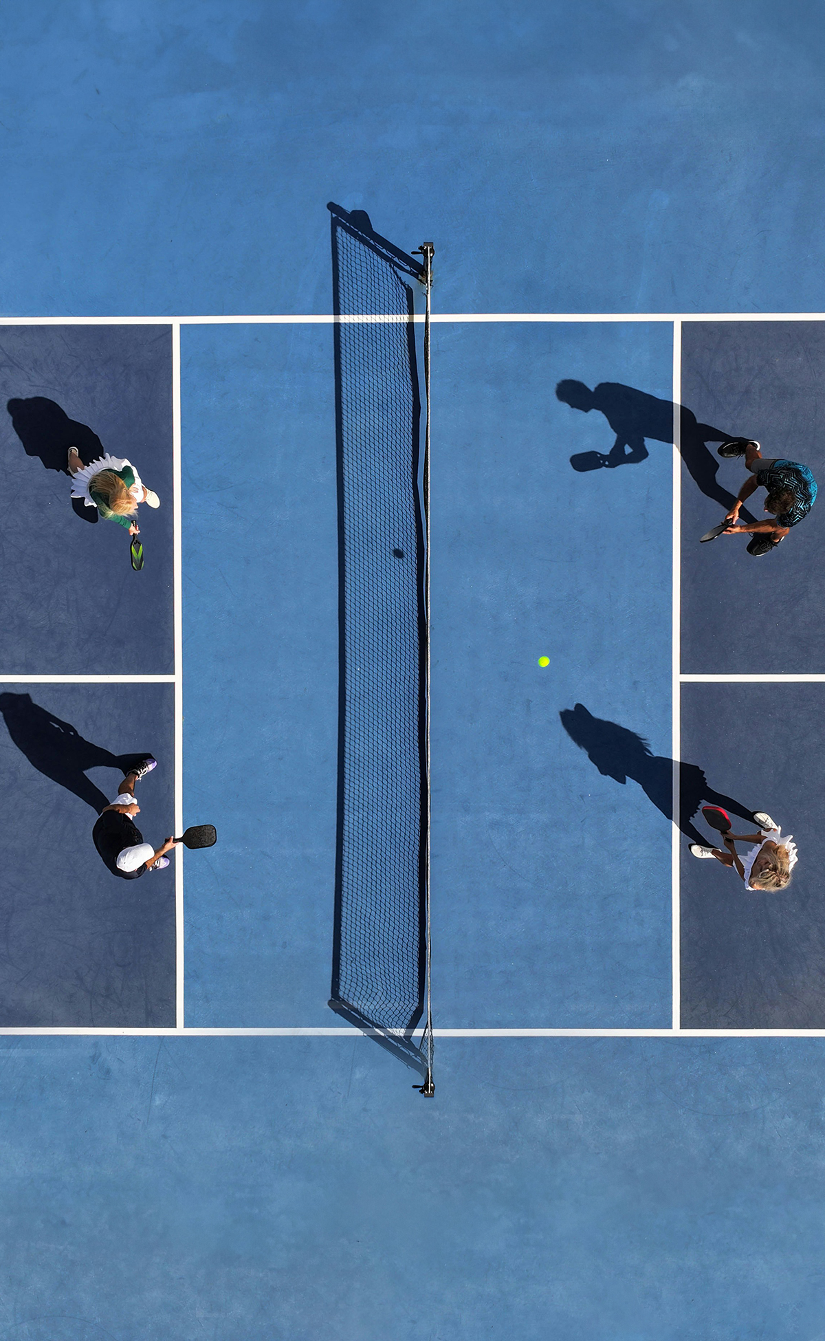 March Impact Grants Update: arial view of 4 people playing pickleball